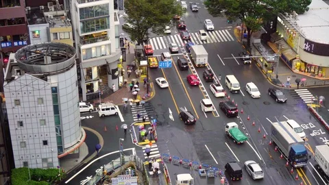 Looking Down on Busy Traffic and Stores in Ginza District of Tokyo Stock Footage 104416481