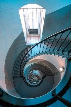 Looking down circular staircase inside historic lighthouse Stock Photos