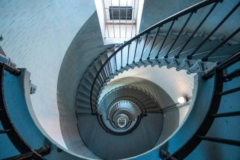 Looking down circular staircase inside historic lighthouse Stock Photos
