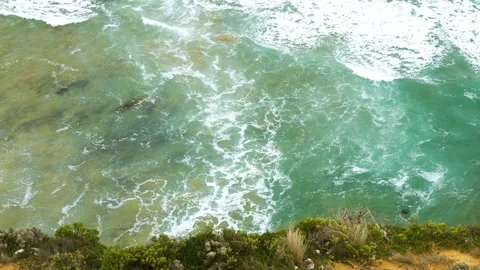 Looking down cliff at blue ocean Stock Footage 274345342