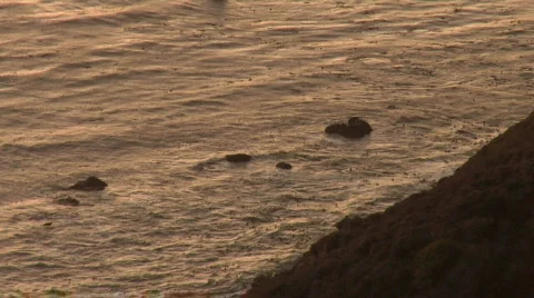 Looking Down Cliff at Ocean During Sunset Stock Footage 689293