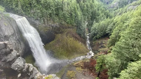 Looking down off cliff of waterfall in lush green forest Stock-Footage 329449191