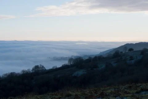 Looking down on a cloud inversion on frosty winters day in the countryside. Stock Photos