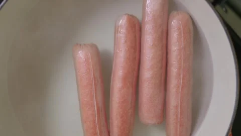 Looking down at Cooking Hot Dogs in Water Stock Footage 315593780