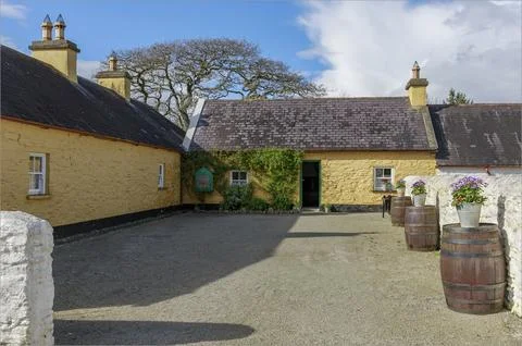 Looking down a court yard at a small cottage Stock Photos