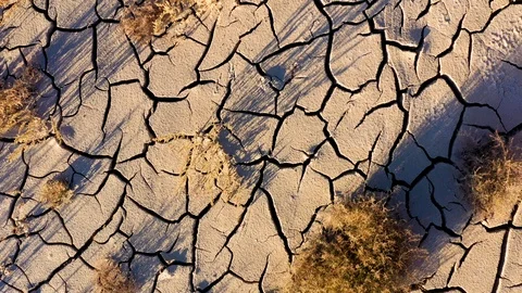 Looking down at the cracked surface of a dry river Stockbeeldmateriaal 125794750