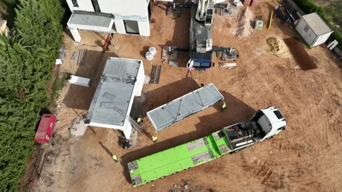 Looking down at crane installing modular home units to construction site Vídeos de archivo 224337129