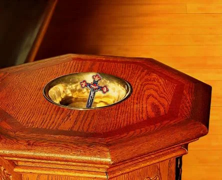 Looking down on crucifix in topy ob baptism font Fotos de archivo