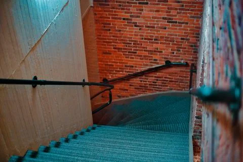 Looking Down Dark Stairs In A Brick Building Inside At Night Stock Photos