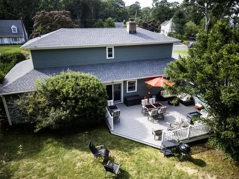 Looking down at a deck on the back of a house set up for a party Stock Photos
