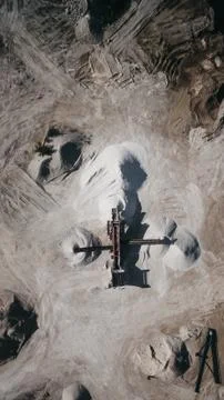 Looking down Drone view of huge mine pit with moonlike appearance. Stock Photos
