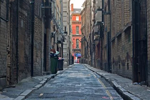 Looking down an empty inner city alleyway Stock Photos