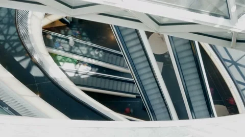 Looking down on escalator. modern shopping center. people persons customers Stock Footage 64541337