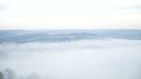 Looking down on evening fog in a valley Stock Footage 144681557
