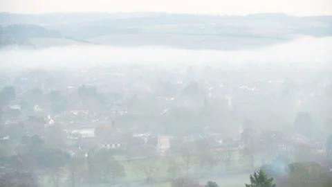 Looking down on evening fog in a valley Stock Footage 144681563