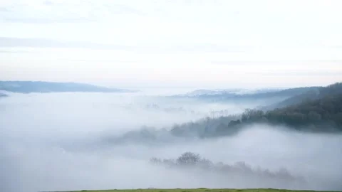 Looking down on evening fog in a valley Stock Footage 144681571