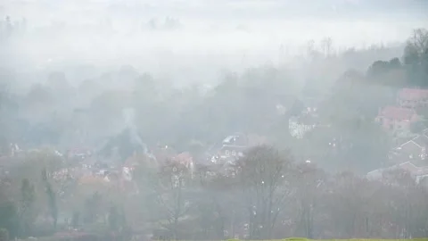 Looking down on evening fog in a valley Stock Footage 144681572