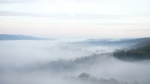 Looking down on evening fog in a valley Stock Footage 144681574