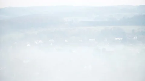 Looking down on evening fog in a valley Stock Footage 144681583