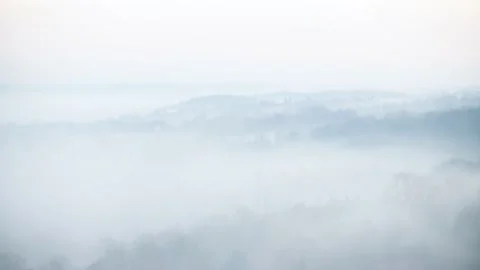 Looking down on evening fog in a valley Stock Footage 144681587