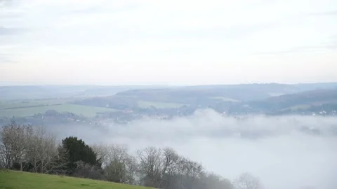 Looking down on evening fog in a valley Stock Footage 144681589