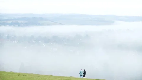Looking down on evening fog in a valley Stock Footage 144681607