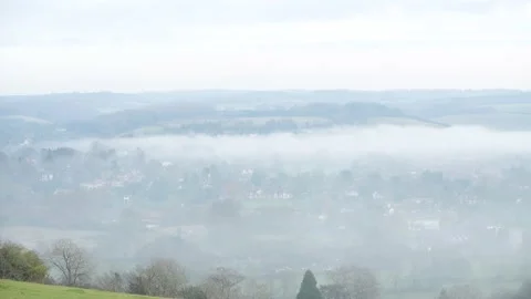 Looking down on evening fog in a valley Stock Footage 144681610