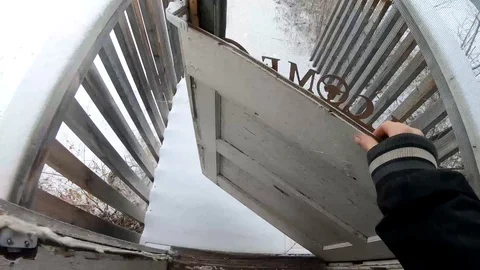 Looking down at feet opening the front door of a home and walking out into Stock Footage 120372292