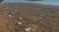 Looking down at a flood wash after takeoff with zoom in on freeway HD Footage