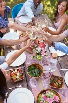 Looking Down On Friends Making A Toast At Outdoor Party Foto stock
