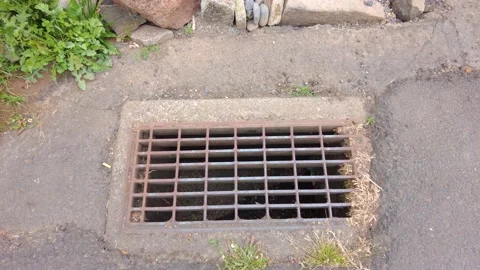 Looking Down a Grate in the Street Stock Footage 154482692