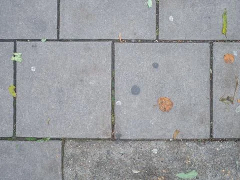 Looking down at grey concrete paving slabs Stock Photos