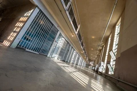Looking down the hallway of a prison Stock Photos