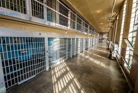Looking down a hallway of a prison Stock Photos