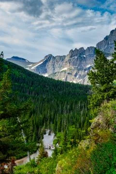Looking down from high above as a storm begins to develop as hikers m Stock Photos
