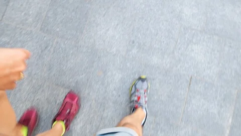 Looking down high angle view of couple legs walking on paved street sidewalk Stock-Footage 112759347