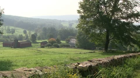 Looking down a hill to a farm on a misty day (1 of 6) Stock Footage 10772685