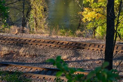 Looking Down a Hill at Train Tracks and a River Stock Photos