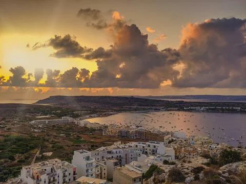 Looking down from the hills as the sun sets over Mellieha in Malta 스톡 사진