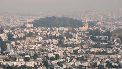 Looking down on homes built onto a hillside during a foggy San Francisco Morning Video stock 89237561