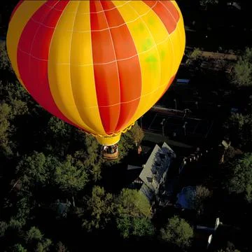 Looking Down on a Hot Air Balloon Floating Low over a Neighborhood Stock Photos