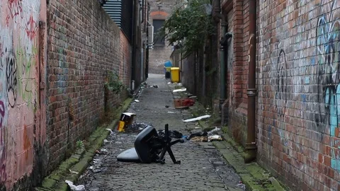 Looking down an inner-city garbage strewn alleyway Stock Footage 70383415