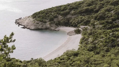 Looking down on an isolated beach with a house but no people Stock Footage 127691904
