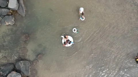 Looking down at kids playing in the fish ponds of Launiupoko Beach Park on Maui Stock Footage 131335304