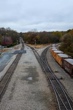 Looking down on a line of loaded rail cars loaded with gravel. Stock Photos