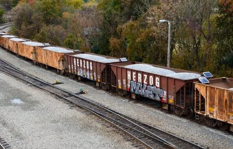 Looking down on a line of loaded rail cars loaded with gravel. Stock Photos