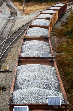 Looking down on a line of loaded rail cars loaded with gravel Stock Photos