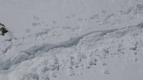Looking down on a lone hiker walking across a snow-covered path Stock-Footage 90880603