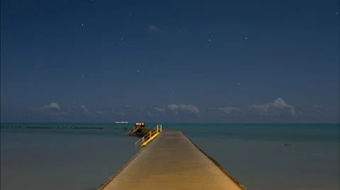 Looking down a long dock going into the ocean time lapse Stock Footage 11113976