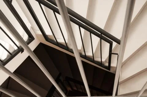 Looking down on a modern, black and white spiral staircase Stock Photos